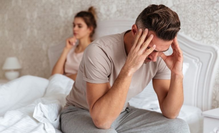sad couple in bedroom